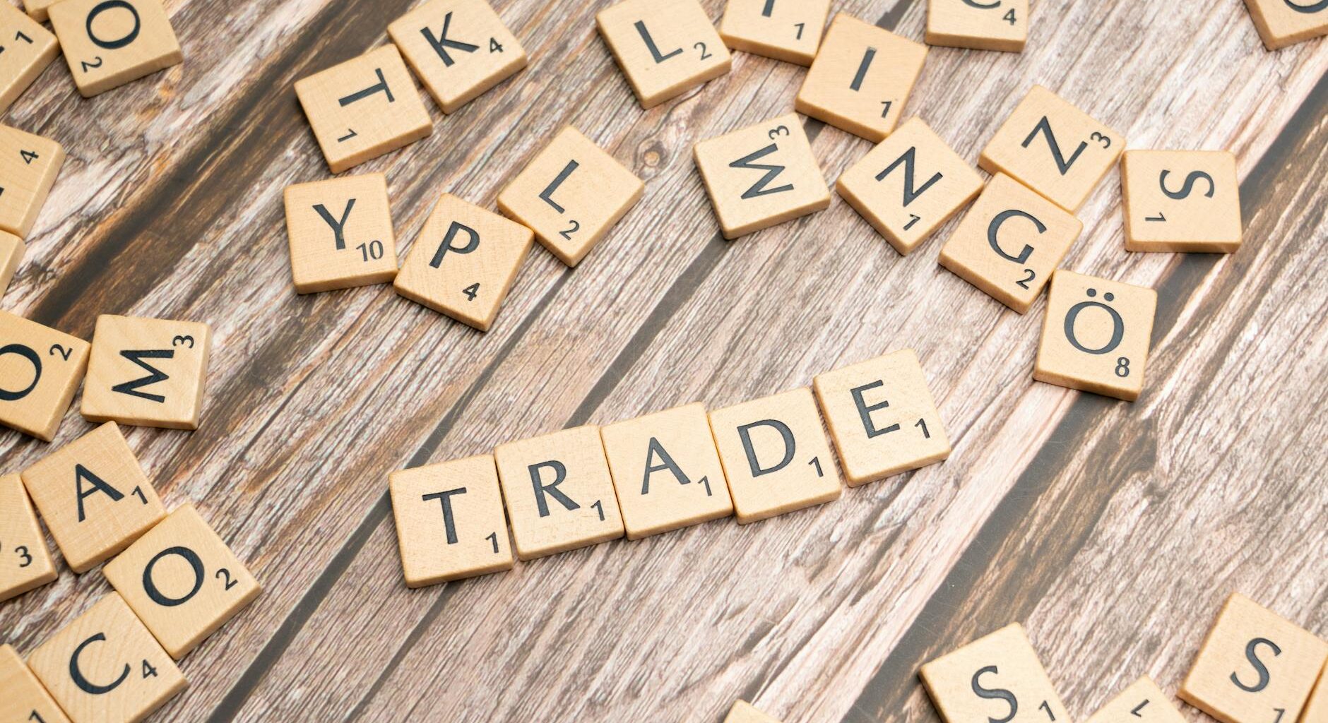 trade and trade related words on wooden table